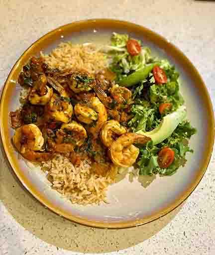 Camarones a la Veracruzana with succulent shrimp cooked in a tangy tomato, olive, and caper sauce, served with rice and beans, a delicious seafood dish at Tequileros restaurant in Frisco, Collin County, Texas.