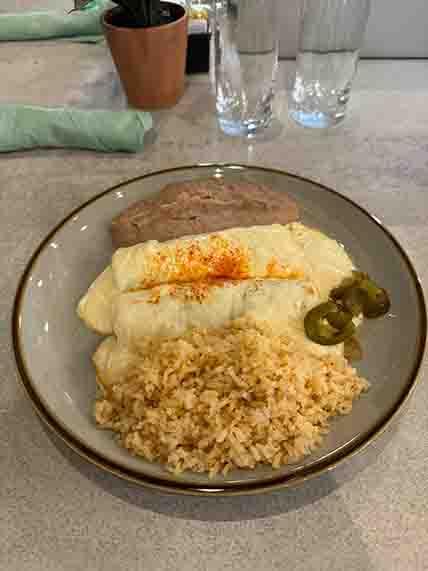 Number 5 special featuring two beef enchiladas topped with creamy sour cream and melted cheese, a savory favorite at Tequileros Tex-Mex restaurant.