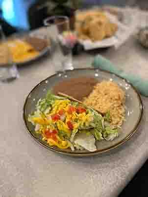 Number 4 plate with two crispy beef tacos, served with Mexican rice and refried beans, a crunchy Tex-Mex favorite at Tequileros restaurant.