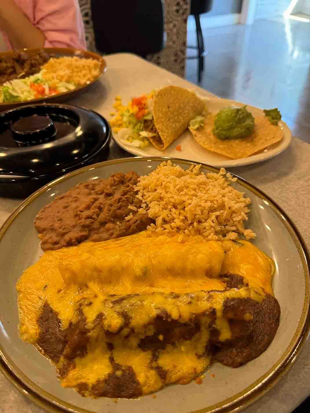 One Tamale topped with Chile con Carne, one Cheese Enchilada topped with Queso, one Crispy Beef Taco and a Guacamole Tostada. Served with Rice and Beans