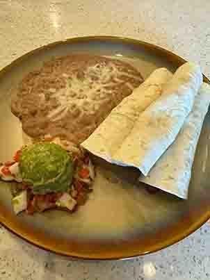 Tacos Al Carbon with smoky grilled beef, served in warm tortillas and topped with fresh onions and cilantro, a flavorful Tex-Mex classic at Tequileros restaurant in Frisco, Collin County, Texas.